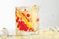 Glass of rum, ice, lemon and cranberry with splash Royalty Free Stock Photo