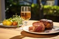 glass of saison with table setting of marinated barbecue meats