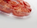 Glass salad bowl filled with raw tomato slices Royalty Free Stock Photo