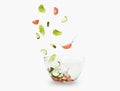 Glass salad bowl in flight with vegetables: tomato, cucumber and leaf salad. Isolated on white background. healthy diet Royalty Free Stock Photo