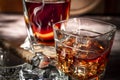 A glass of scotch whiskey with ice and a cigar on a wooden table close-up. Royalty Free Stock Photo