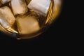 Glass of scotch whiskey and ice over black background Royalty Free Stock Photo