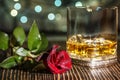 Glass of scotch whiskey and ice , red rose Royalty Free Stock Photo