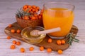 A glass of sea buckthorn juice with honey. Royalty Free Stock Photo