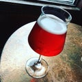 Glass of seasonal cherry beer on a bar table Royalty Free Stock Photo