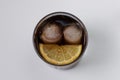 glass seen from above with soft drink, ice cubes and lemon that looks like a face with a smile Royalty Free Stock Photo