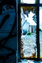 Shattered glass window panes of abandoned building