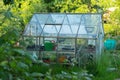 A glass shed or greenhouse in an allotment garden Royalty Free Stock Photo