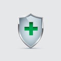 Glass Shield with silver frame and Green Cross isolated on gray. Vector Health Protection icon. Royalty Free Stock Photo