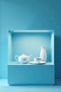 Glass showcase, blue backdrop, pristine white china, simple setting , aesthetic, tableware Royalty Free Stock Photo