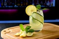 A GLASS WITH A SICILIAN LEMON DRINK IN THE BACKGROUND BLURRED IMAGE