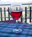 A glass of Sicilian red wine on the table covered with checkered tablecloth Royalty Free Stock Photo