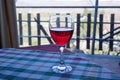 A glass of Sicilian red wine on the table covered with checkered tablecloth Royalty Free Stock Photo