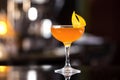 Glass of sidecar orange cocktail decorated with lemon at bar Royalty Free Stock Photo