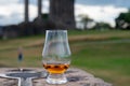 Glass of single malt scotch whisky and view from Calton hill to park and old parts of Edinburgh city in rainy day, Scotland, UK Royalty Free Stock Photo