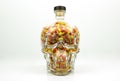 Glass skull filled with candy corn isolated Royalty Free Stock Photo