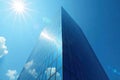 Glass skyscraper, blue sky reflection, low angle , downtown, sunlight Royalty Free Stock Photo