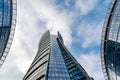 Glass skyscrapers of irregular shape. Bottom view. Abstract architectural detail of corporate building suitable as Royalty Free Stock Photo