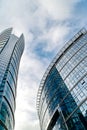 Glass skyscrapers of irregular shape. Bottom view. Abstract architectural detail of corporate building suitable as background Royalty Free Stock Photo