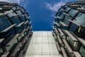 Glass skyscrapers of irregular shape. Bottom view. Abstract architectural detail of corporate building suitable as background. Royalty Free Stock Photo
