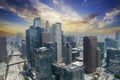 glass skyscrapers, office buildings and hotels in the city skyline with cars driving on the freeway, lush green trees