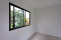 Glass slide window replacement on white wall of house