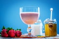 Glass of smoothie with fresh strawberries, honey and yogurt Royalty Free Stock Photo
