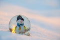 Glass snowball with snowman in the snow.