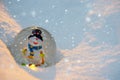Glass snowball with snowman in the snow