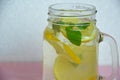 Glass of soda drink with lemon slices and mint on pink background. From top view. glass of lemon ice tea or detox water. health Royalty Free Stock Photo