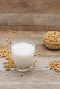 Glass with soy milk and soy bean on wooden background Royalty Free Stock Photo