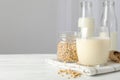 Glass of soy milk, soybeats seeds, bottle with milk on white background Royalty Free Stock Photo