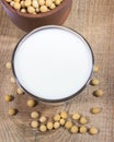 Glass of soy milk on a wooden background. Royalty Free Stock Photo