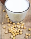 Glass of soy milk on a wooden background. Royalty Free Stock Photo