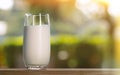 Glass of soy milk on a wooden table on a natural nature background. Sunny day Royalty Free Stock Photo