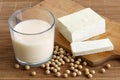 Glass of soya milk with froth on bamboo mat with spilled soya be