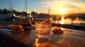 glass of sparkling orange water and sunglasses relaxing on beach at sunset