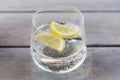 Glass of sparkling water with lemon on table