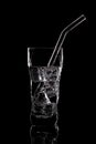 Glass of sparkling water soda drink with ice on black background Royalty Free Stock Photo