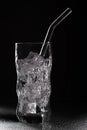 Glass of sparkling water soda drink with ice on black background Royalty Free Stock Photo