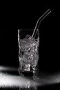 Glass of sparkling water soda drink with ice on black background Royalty Free Stock Photo