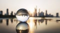 Glass sphere capturing an inverted city view and sunset hues, focusing on interconnectedness, urban development, and perspective Royalty Free Stock Photo