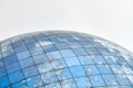 Glass spherical modern building with reflection of blue sky Royalty Free Stock Photo