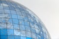 Glass spherical modern building with reflection of blue sky Royalty Free Stock Photo