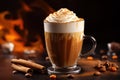 glass with spiced latte, cinnamon sticks, coffee beans and pumpkin on a dark background. Royalty Free Stock Photo