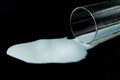 A glass of spilled milk on a black background. Royalty Free Stock Photo