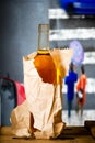 Glass of spirits in the paper bag