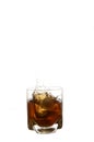 Glass with splash of whisky with ice cube Royalty Free Stock Photo
