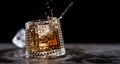 Glass of splashing whiskey with icecube on stone table, on black background