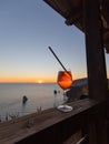 A glass of spritz in front of a beautiful sunset Royalty Free Stock Photo